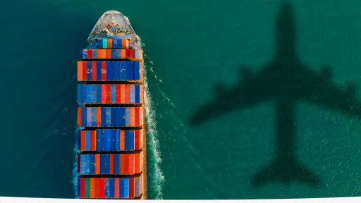 plane and its shadow in the water