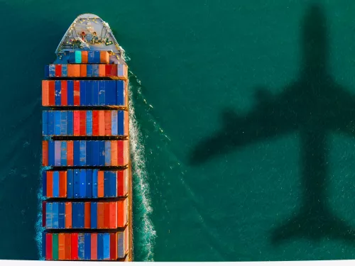 plane and its shadow in the water